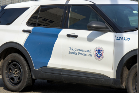 U.S. Customs and Border Protection sign and Department of Homeland Security logo on side of a work vehicle car parked near import shipping dock in Bayonne New Jersey US.