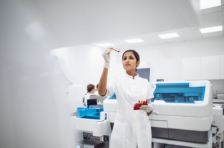 A young Indian female lab professional in a bright, modern laboratory